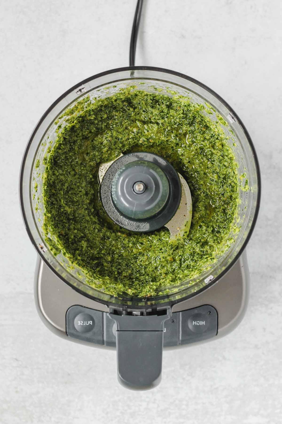 food processor with blended kale pesto sauce