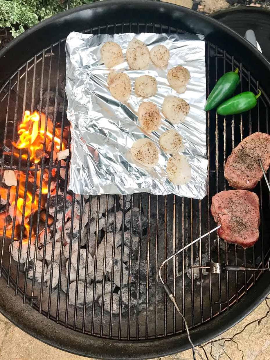 Scallops with steak and jalapeños on weber grill with flame over indirect heat
