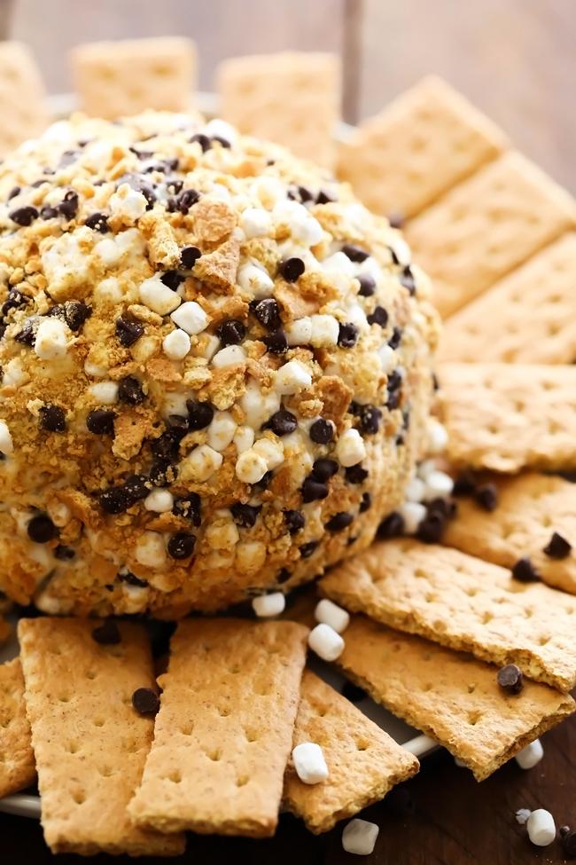 S'more Cheese Ball... Marshmallows, chocolate and graham crackers combine to make one delicious sweet cheese ball. It is everything you love about s'mores wrapped up into on tasty dessert appetizer!