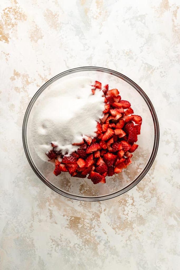 Sugar and strawberries in a dish.