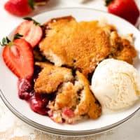 Top down view of strawberry cobbler on a plate.