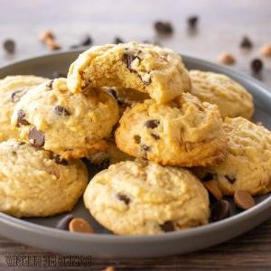 chocolate chip butterscotch cookies recipe piled on a serving plate with top cookie missing a bite